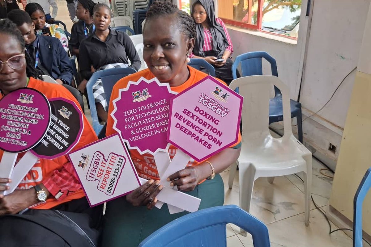 Participants hold advocacy placards during the session.